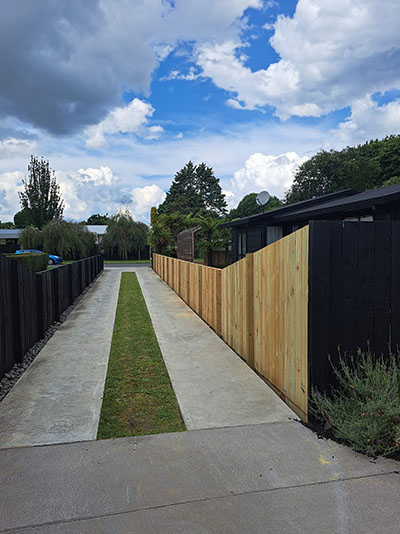 New timber fence along a driveway at a house